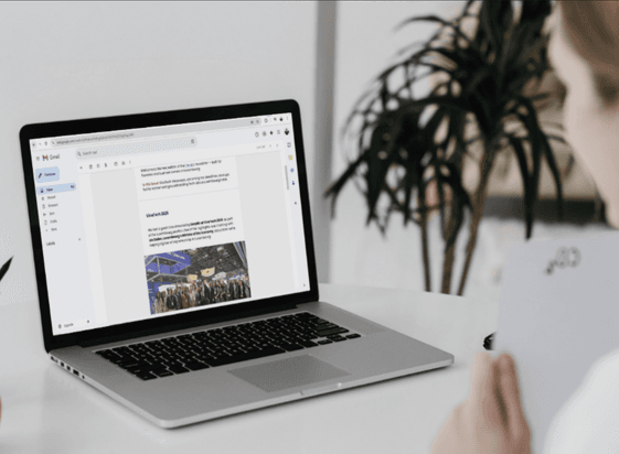 A laptop on a desk showing the EasyBiz newsletter in an email inbox