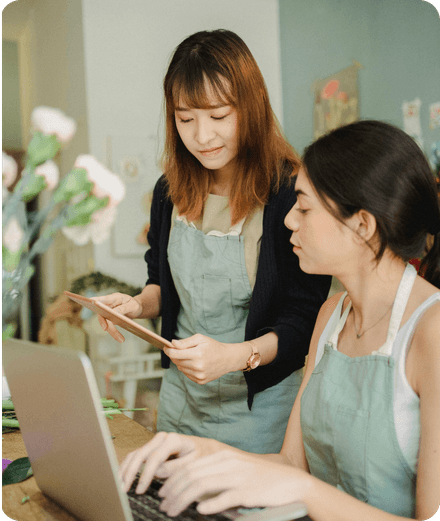 A business owner creating invoices on her laptop