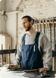 Craftsman in an apron working at his workbench
