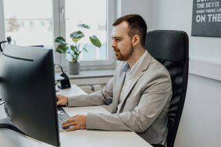 A man working at a computer in a bright office