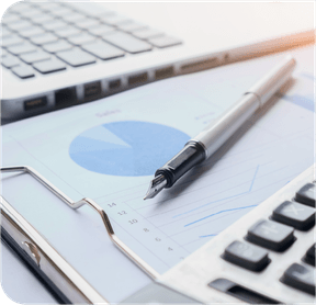 A pen and a calculator on financial charts